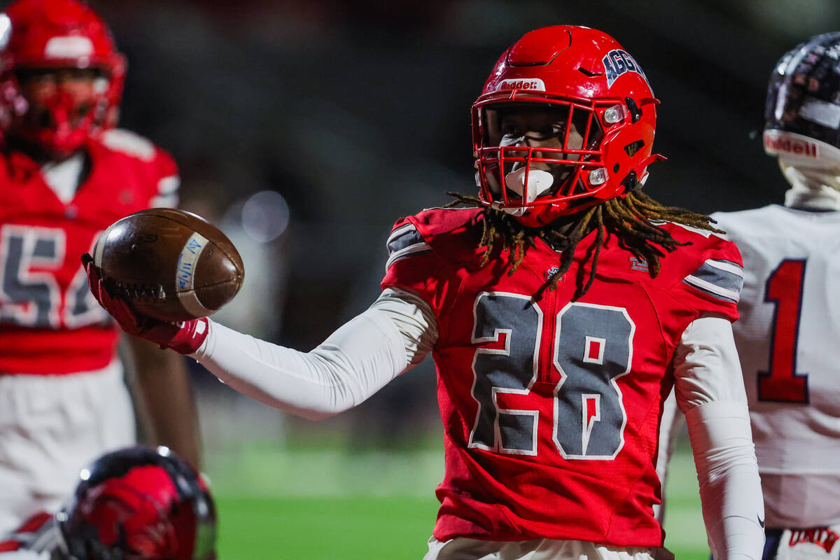 Arbor View running back Nylen Johnson (28) hoists the ball after a touchdown during a Class 5A ...