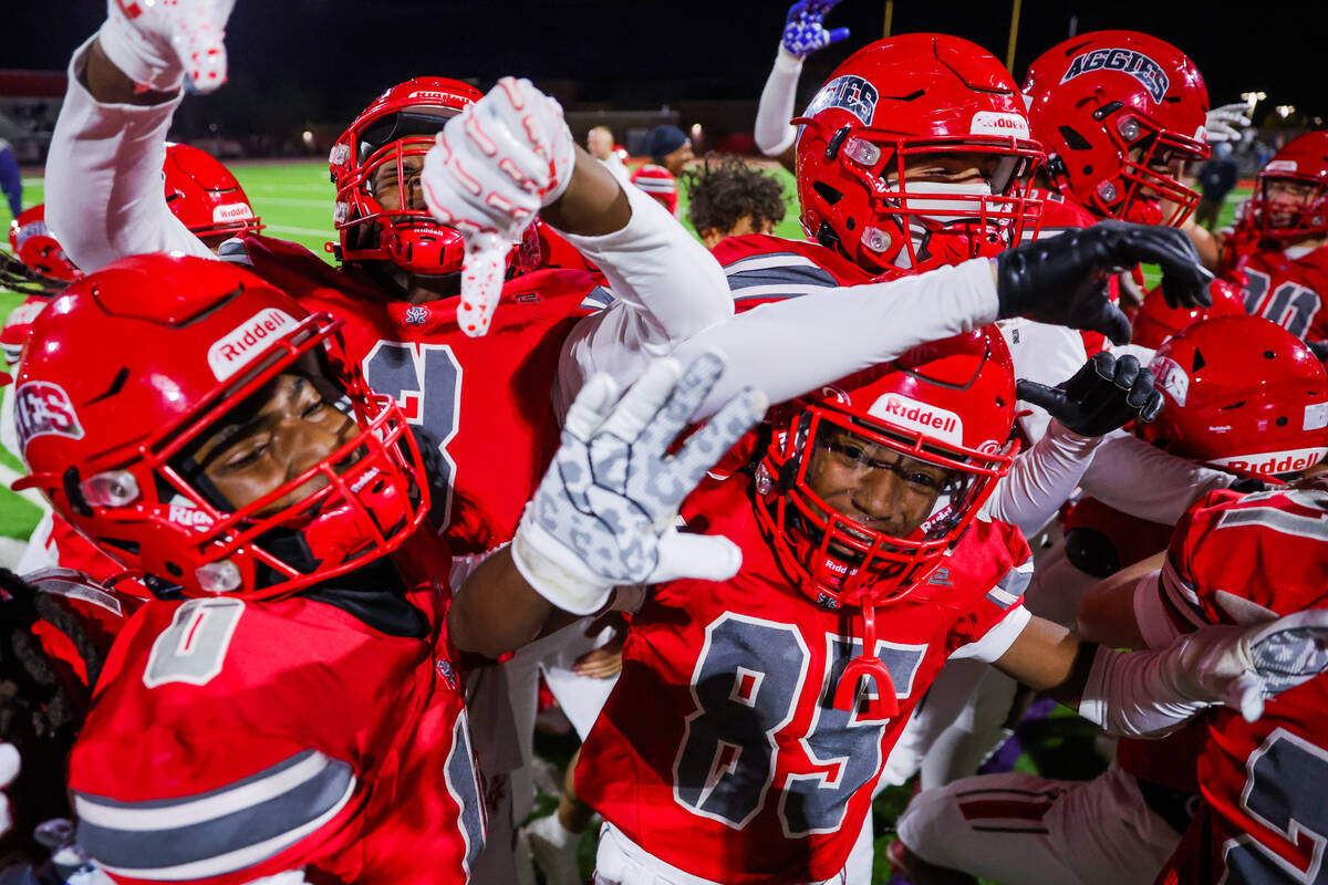 Arbor View teammates celebrate winning a Class 5A Division I state semifinal football game betw ...