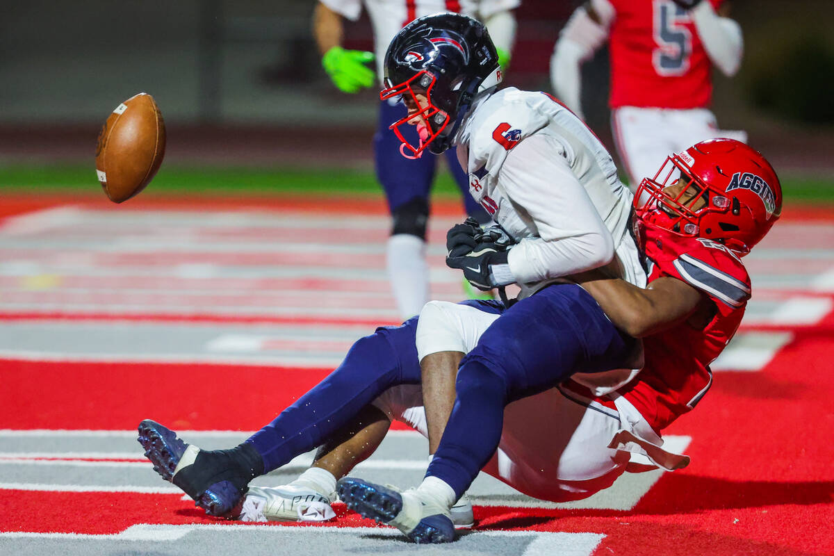 Arbor view cornerback pulls Coronado athlete JJ Buchanan (6) away from a throw meant for him in ...