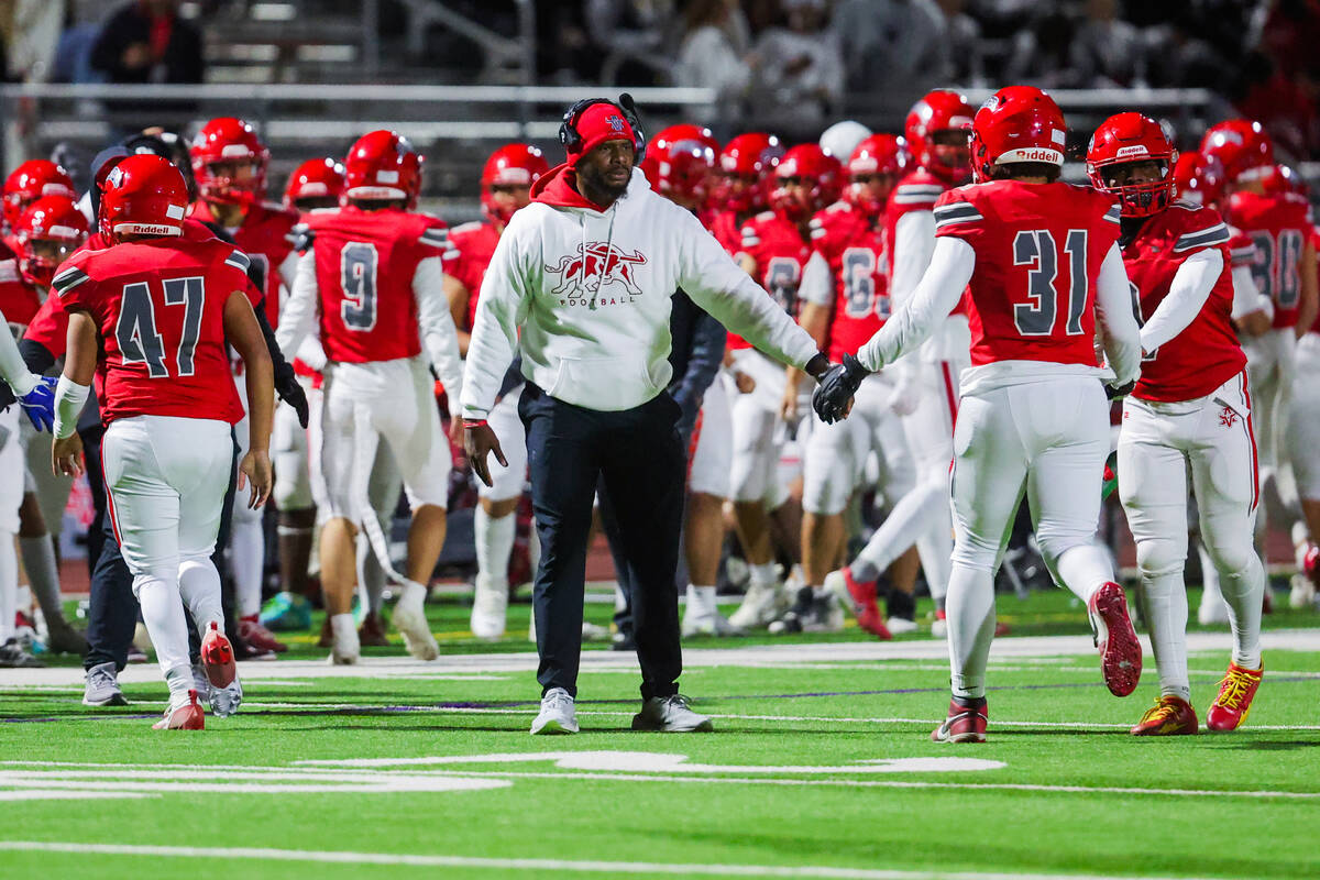 Arbor view head coach Marlon Barnett high-fives his players during a Class 5A Division I state ...