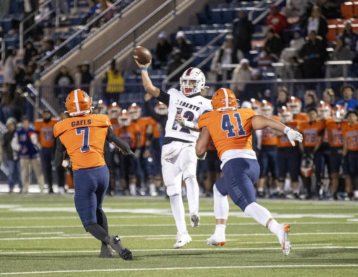 Liberty quarterback Elijah Espinoza (12) throws the ball before being tackled during the Class ...