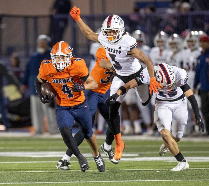 Bishop Gorman wide receiver Kaina Watson (4) avoids Liberty defensemen during the Class 5A Divi ...