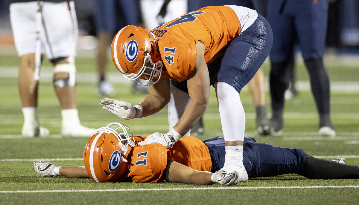 Bishop Gorman defensive lineman Prince Williams (41) playfully wakes up linebacker Landon McCom ...