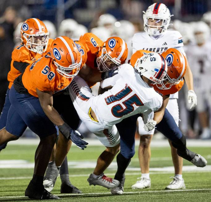 Numerous Bishop Gorman defensemen tackle Liberty wide receiver Amar Pierce (15) during the Clas ...