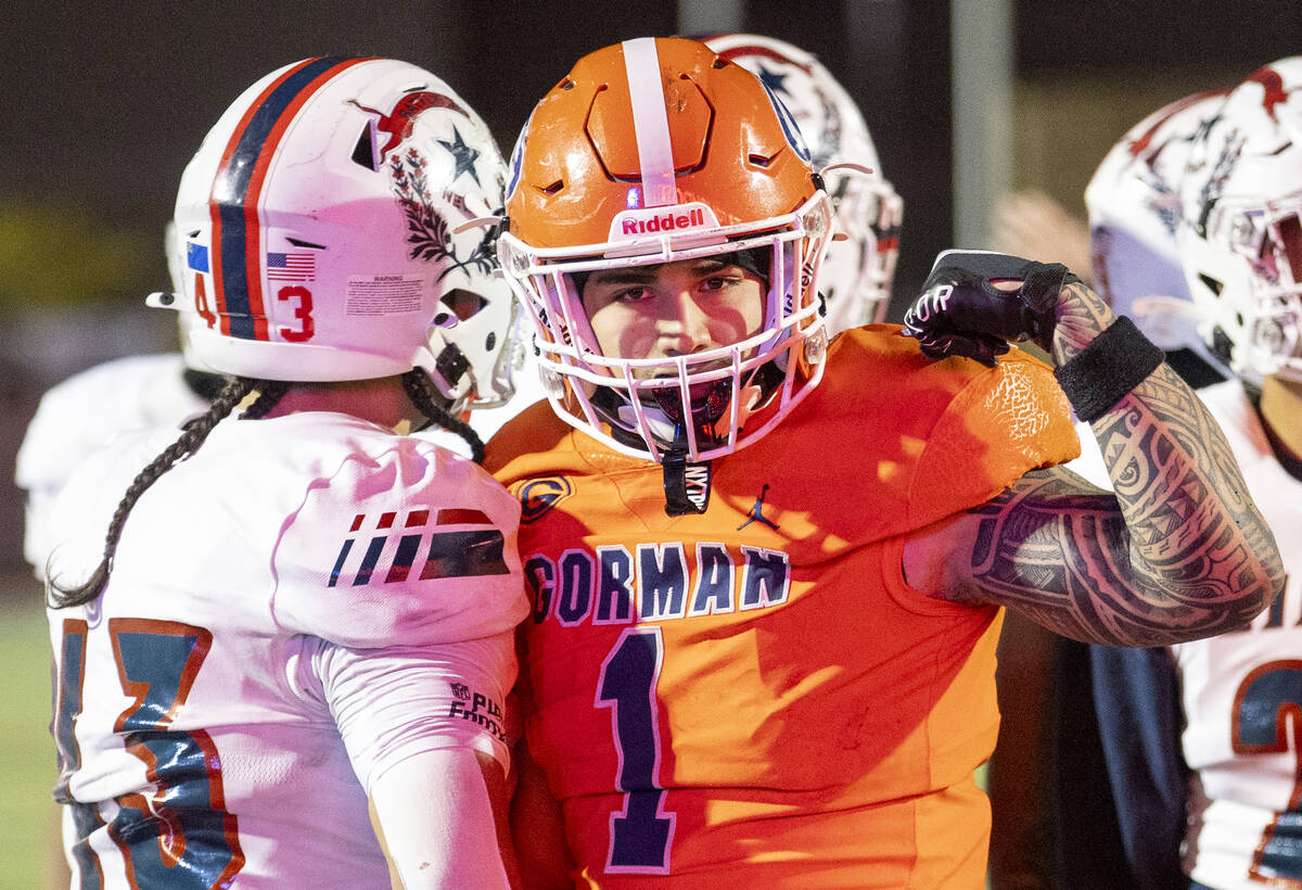 Bishop Gorman linebacker Champ Kapanui (1) flexes after scoring a touchdown during the Class 5A ...