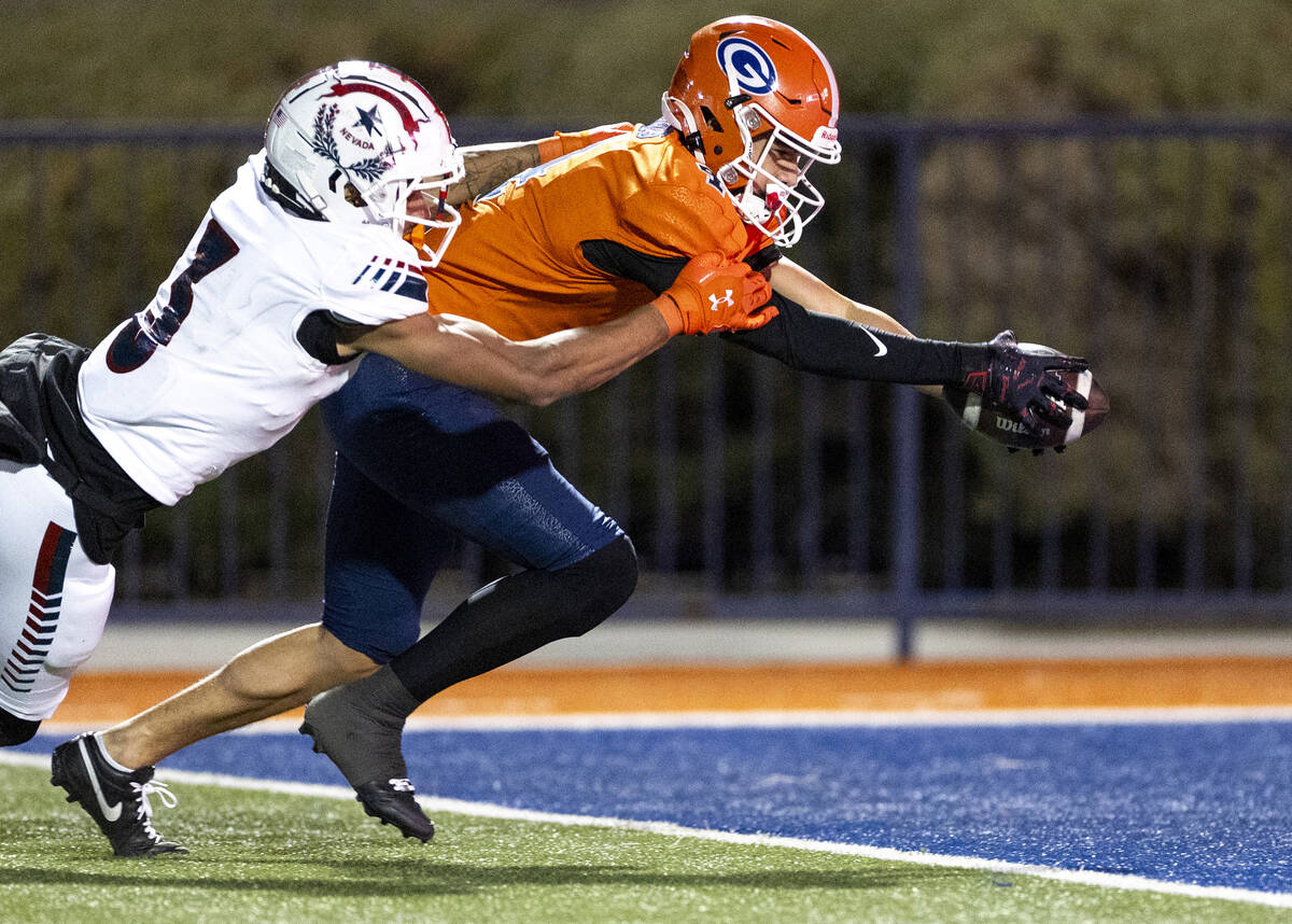 Bishop Gorman wide receiver Kaina Watson, right, stretches for a touchdown as Liberty defensive ...