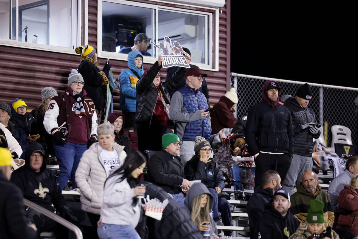 Faith Lutheran fans cheer as their team runs onto the field to take on Shadow Ridge in their NI ...