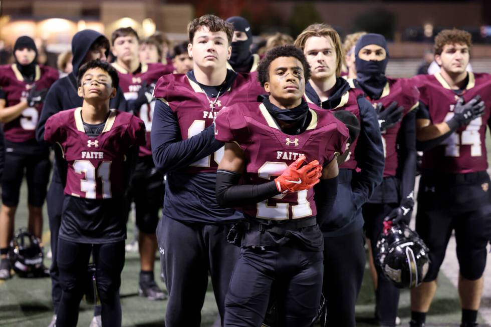 Faith Lutheran stands for the National Anthem before taking on Shadow Ridge in their NIAA Class ...