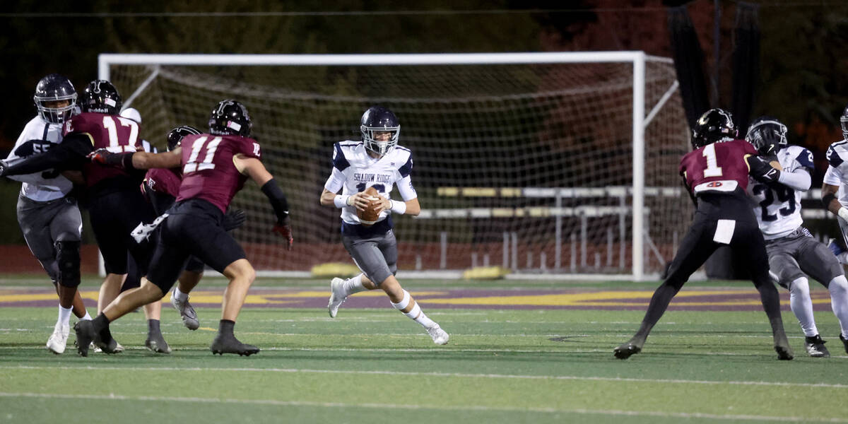 Shadow Ridge quarterback Gage Crnkovic (16) scrambles against Faith Lutheran in the first quart ...