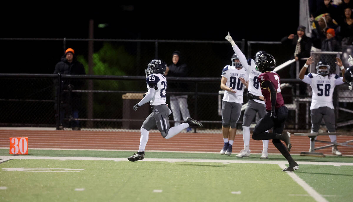 Shadow Ridge fullback Trevin Young (29) runs ahead of Faith Lutheran defensive back Matthew Ma ...