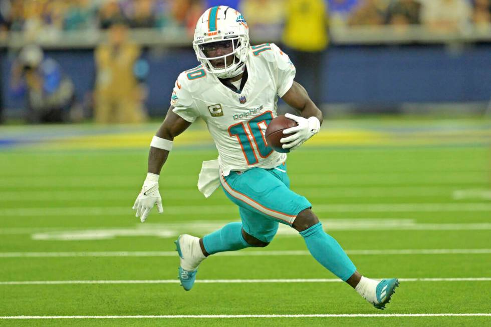 Miami Dolphins wide receiver Tyreek Hill carries the ball during an NFL football game against t ...