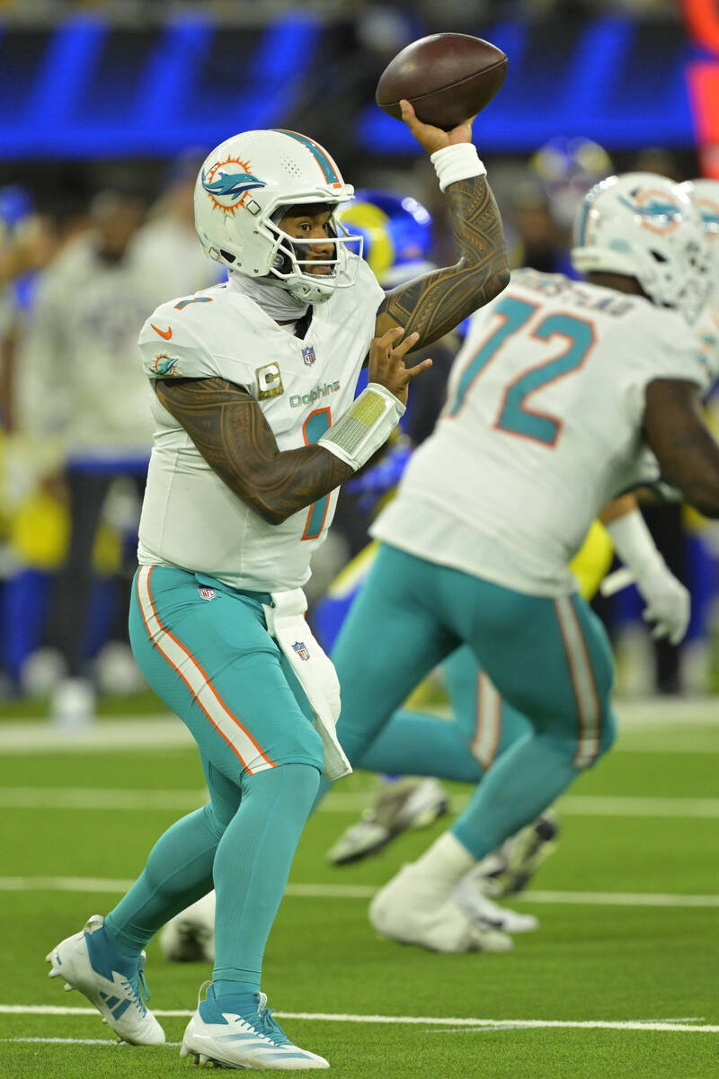 Miami Dolphins quarterback Tua Tagovailoa sets to throw a pass during an NFL football game agai ...