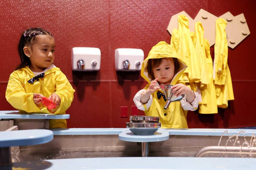 Catalina Cuenca, 2, of Las Vegas, left, and Isabelle Sunwoo, 1, of Great Falls, Mont., explore ...