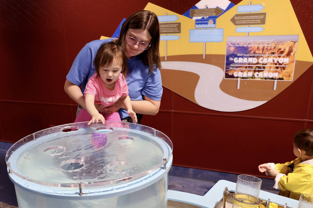 Cosette Sunwoo and her daughter Isabelle Sunwoo, 1, of Great Falls, Mont., watch a ball in the ...