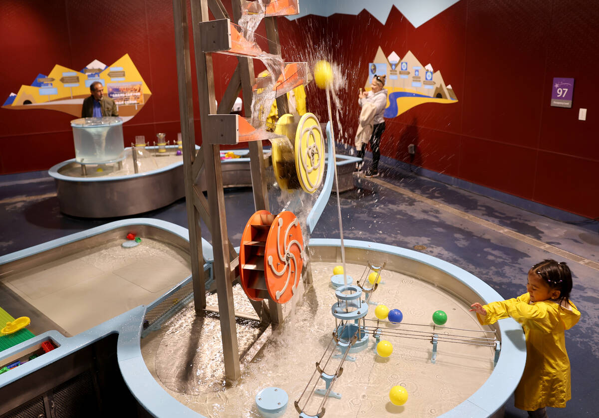 Catalina Cuenca, 2, of Las Vegas sends a ball skyward using a stream of water in the ‘Water W ...