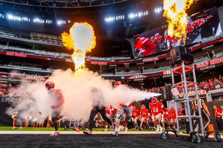 UNLV Head Coach Barry Odom and players take to the field through smoke and fire as the ready to ...