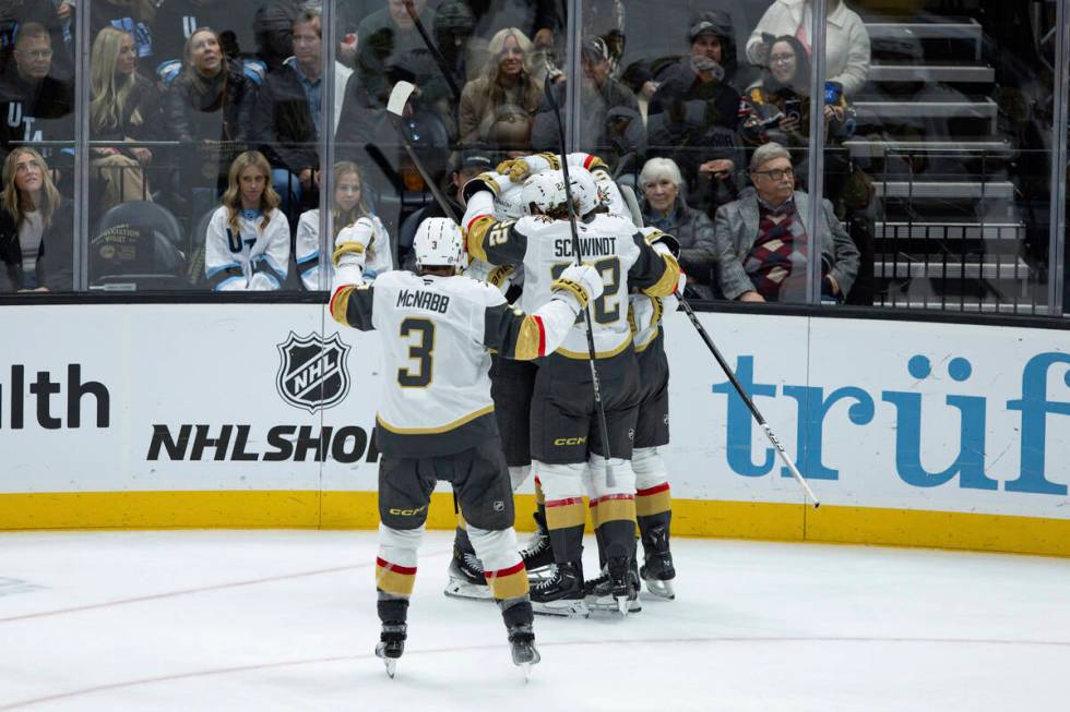 Vegas Golden Knights players celebrate a goal against the Utah Hockey Club during the third per ...