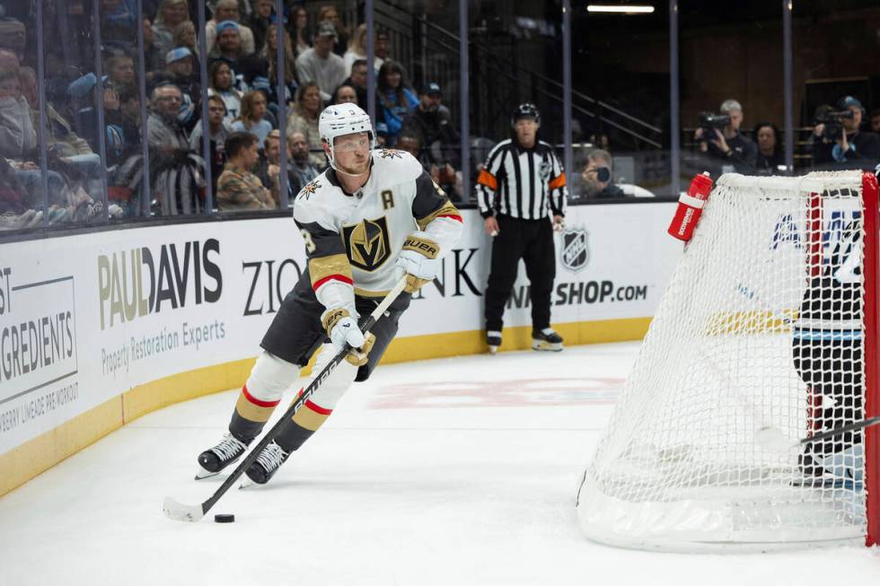 Vegas Golden Knights center Jack Eichel (9) moves the puck against the Utah Hockey Club during ...