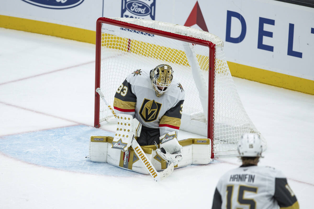 Vegas Golden Knights goaltender Adin Hill (33) saves the puck against the Utah Hockey Club duri ...