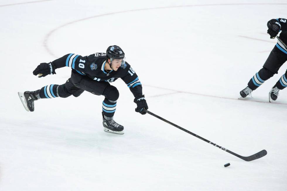 Utah Hockey Club defenseman Maveric Lamoureux (10) goes after the puck during the third period ...