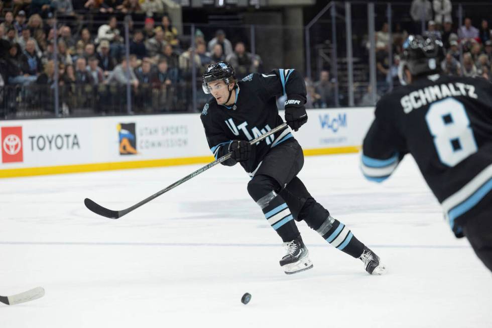 Utah Hockey Club defenseman Michael Kesselring (7) passes the puck to teammate center Nick Schm ...