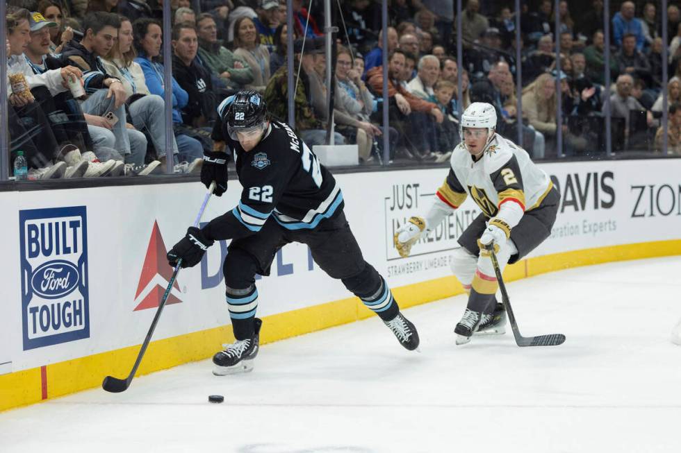 Utah Hockey Club center Jack McBain (22) moves the puck against Vegas Golden Knights defenseman ...