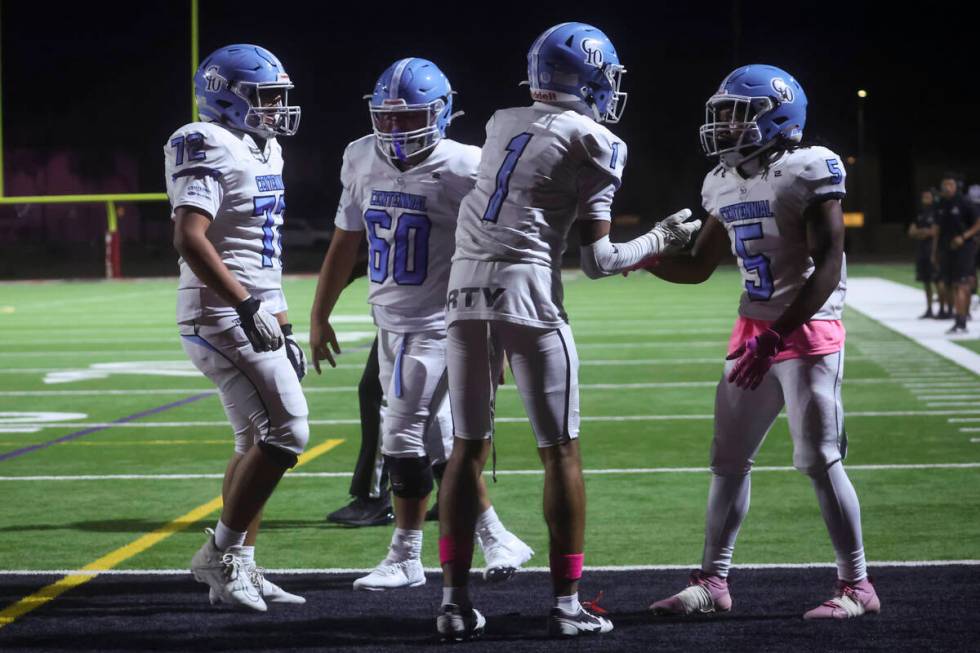 Centennial running back Khy Harris (5) celebrates his touchdown with Jayden Thomas (1) during a ...