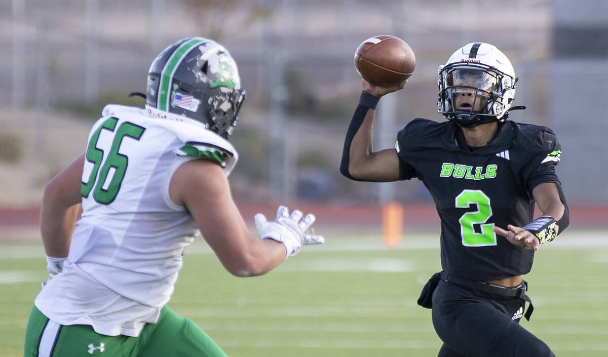 SLAM Academy junior Alaijah Young (2) looks for an open receiver during the 3A state semifinal ...