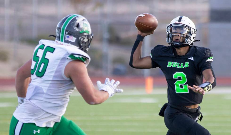 SLAM Academy junior Alaijah Young (2) looks for an open receiver during the 3A state semifinal ...