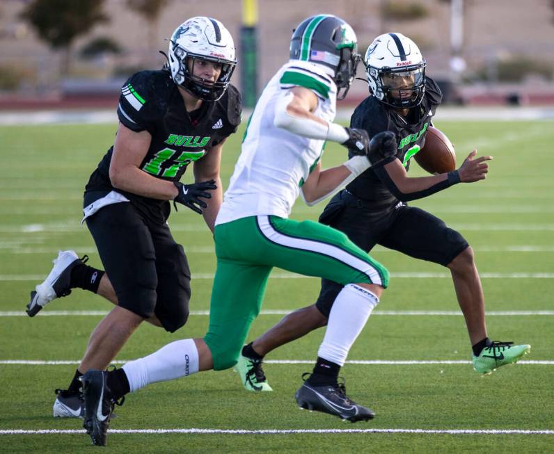 SLAM Academy junior Alaijah Young (2) looks to run the ball during the 3A state semifinal footb ...