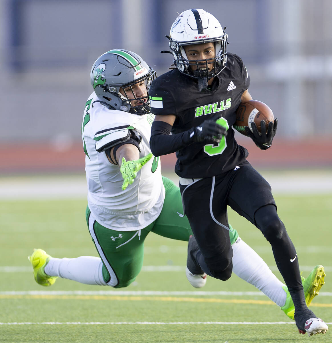 SLAM Academy senior Choy'ce Meloncon, right, avoids Churchill County junior Joseph Romero (61), ...