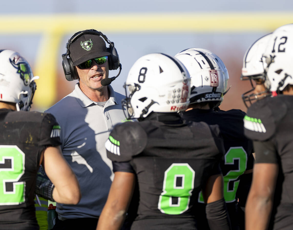 SLAM Academy Head Coach Mike Cofer talks to the team during the 3A state semifinal football gam ...