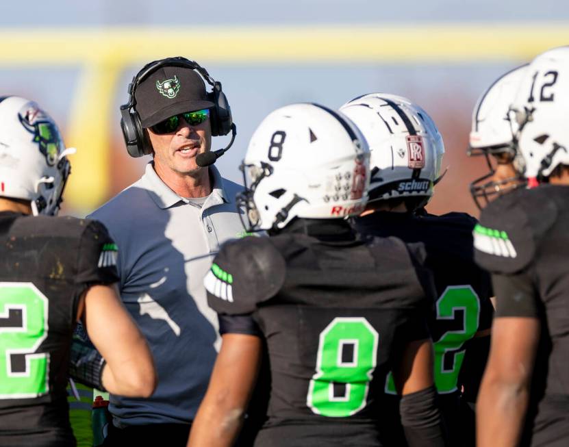 SLAM Academy Head Coach Mike Cofer talks to the team during the 3A state semifinal football gam ...