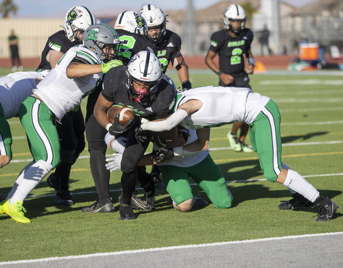 SLAM Academy senior Damien Nevil (12) pushes toward the end zone during the 3A state semifinal ...