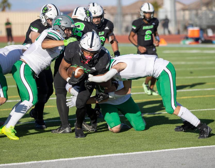 SLAM Academy senior Damien Nevil (12) pushes toward the end zone during the 3A state semifinal ...