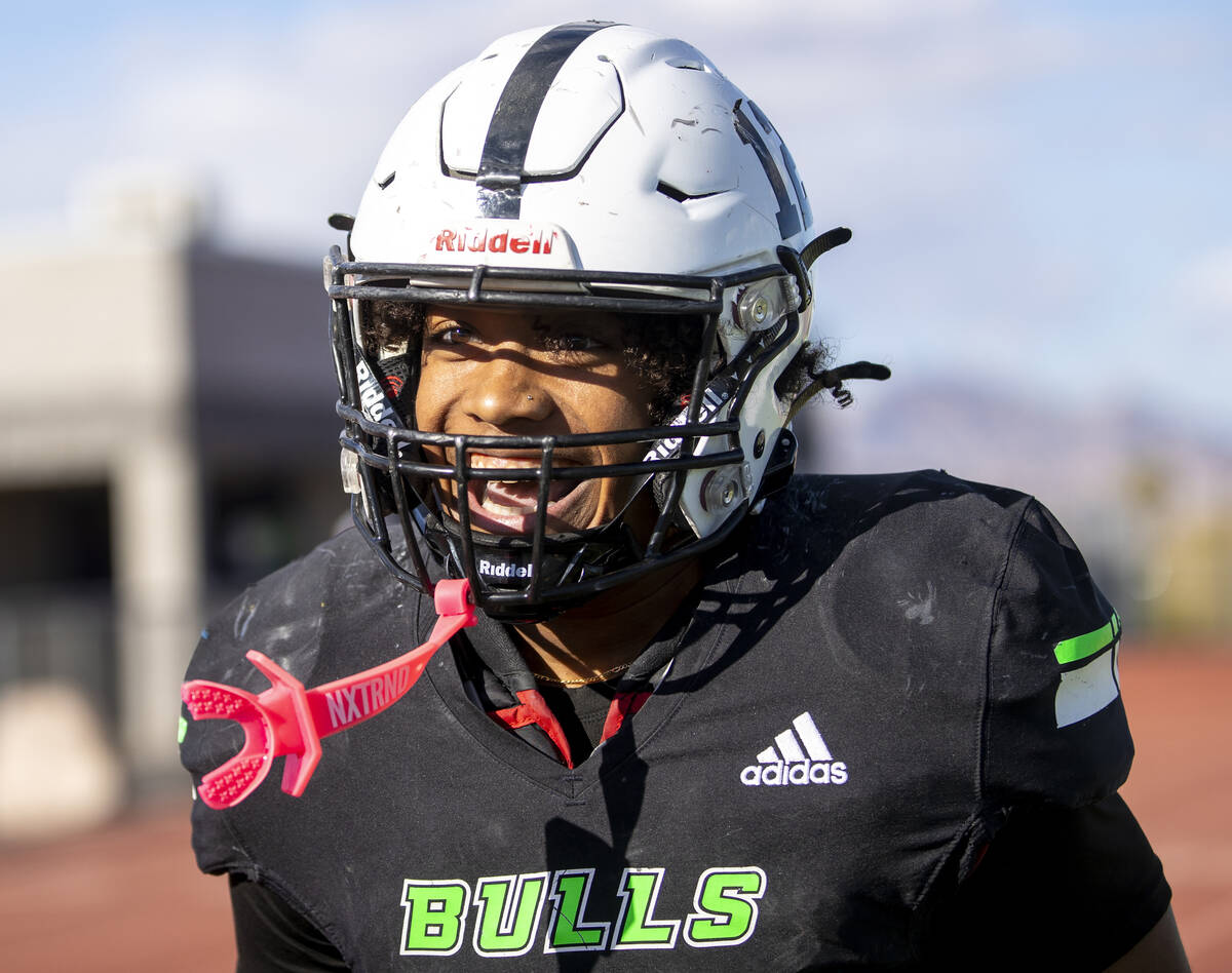 SLAM Academy senior Damien Nevil (12) runs toward the sideline, smiling after scoring a touchdo ...