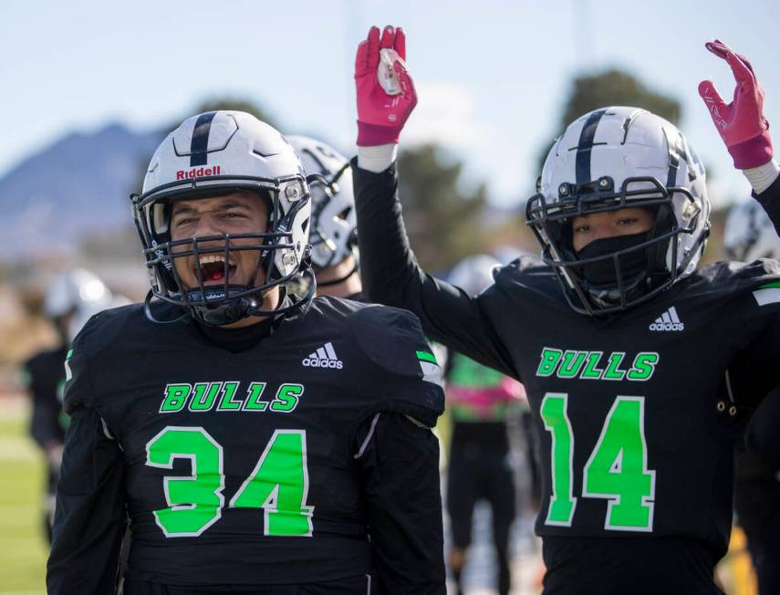 SLAM Academy freshman Czar Soto (34) and freshman Chance Meloncon (14) celebrate after a touchd ...