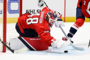 Washington Capitals goaltender Logan Thompson (48) covers the puck during the second period of ...