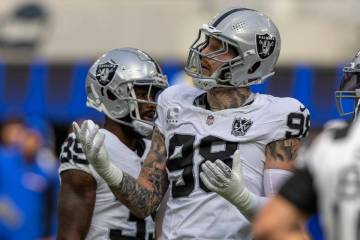 Raiders defensive end Maxx Crosby (98) reacts after being called for roughing the passer on Los ...