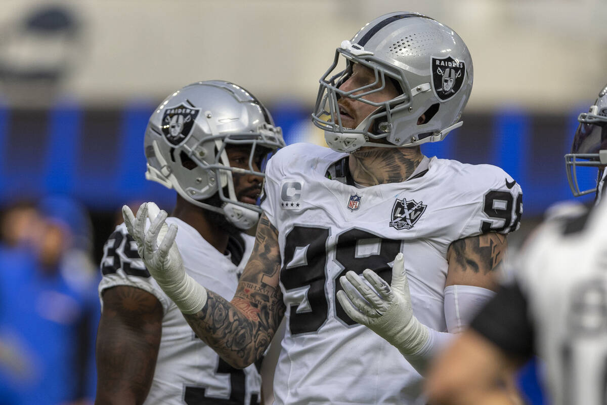 Raiders defensive end Maxx Crosby (98) reacts after being called for roughing the passer on Los ...