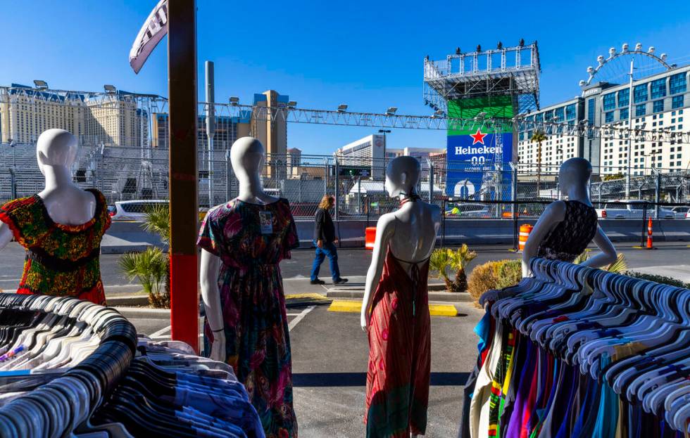 A pedestrian walks past Las Vegas Souvenirs & Gifts as grandstands and race barriers are no ...