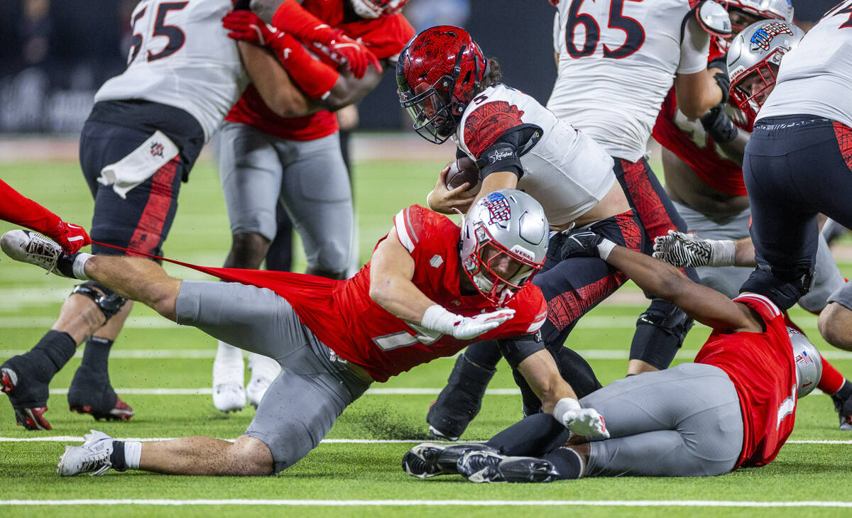 San Diego State Aztecs quarterback Danny O'Neil (5) is sacked by UNLV linebacker Jackson Woodar ...