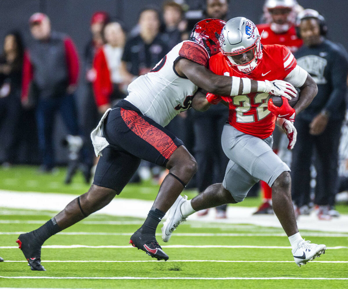 UNLV running back Devin Green (22) battles for more yards as San Diego State Aztecs defensive l ...