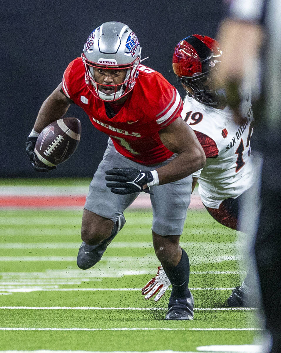 UNLV defensive back Jalen Catalon (1) runs back an interception past San Diego State Aztecs wid ...