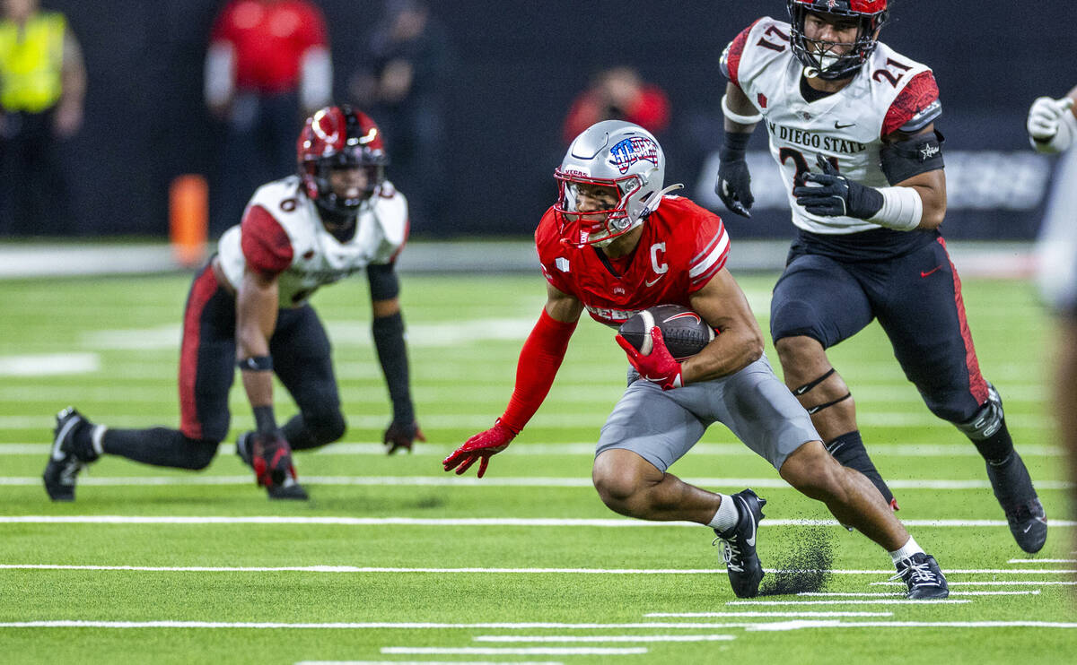 UNLV wide receiver Jacob De Jesus (21) cuts up field after another erection trailed by San Dieg ...