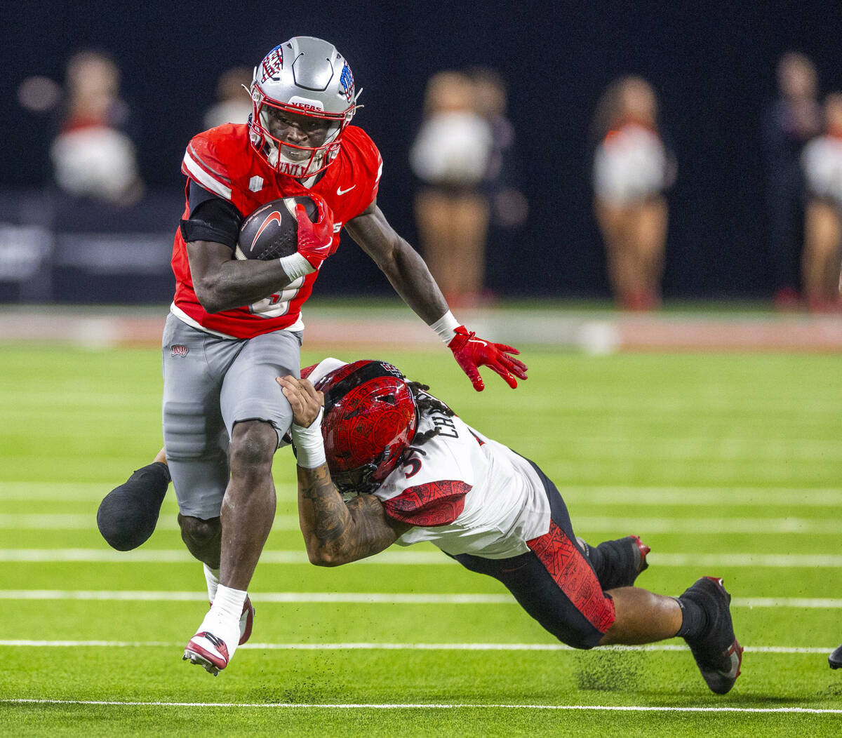 UNLV running back Jai'Den Thomas (9) pulls away from a tackle attempt by San Diego State Aztecs ...