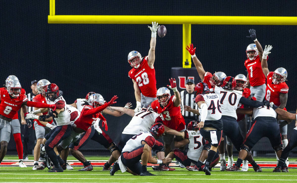 UNLV defensive lineman Fisher Camac (28) elevates for a block attempt on a San Diego State Azte ...