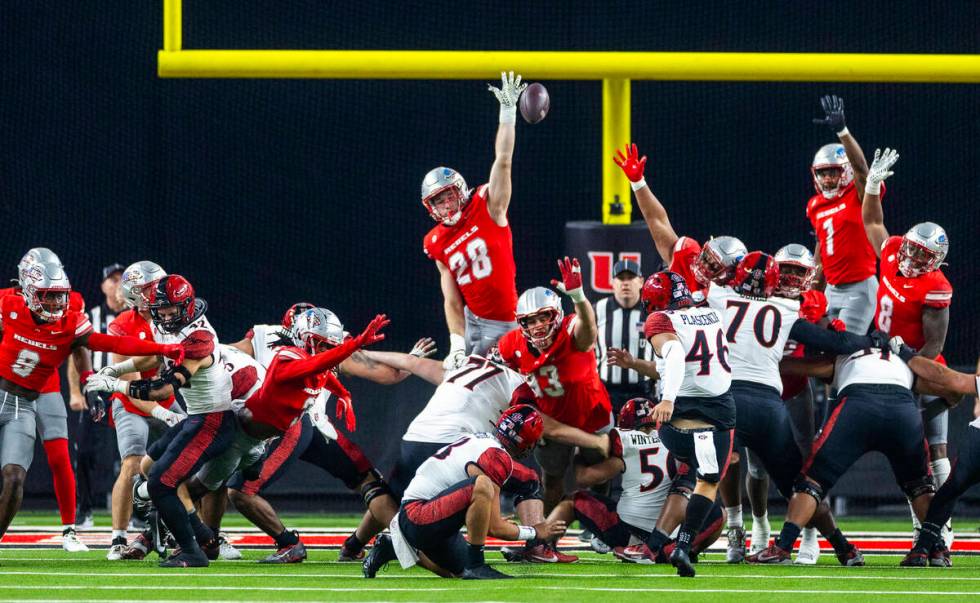 UNLV defensive lineman Fisher Camac (28) elevates for a block attempt on a San Diego State Azte ...