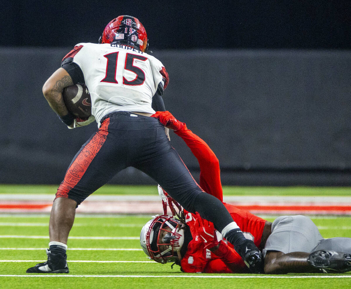 San Diego State Aztecs running back Marquez Cooper (15) fights off tackle attempt by UNLV defen ...