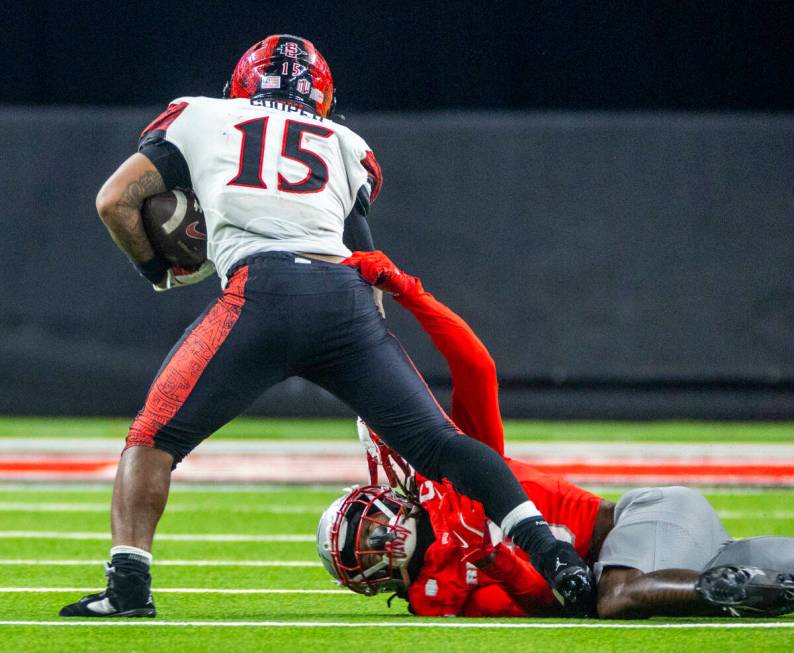 San Diego State Aztecs running back Marquez Cooper (15) fights off tackle attempt by UNLV defen ...